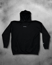 Black hoodie with a brand logo on a gray concrete surface