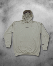 Beige hoodie with branding on a textured gray background