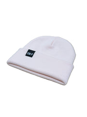 Pink beanie with a logo on a wooden surface